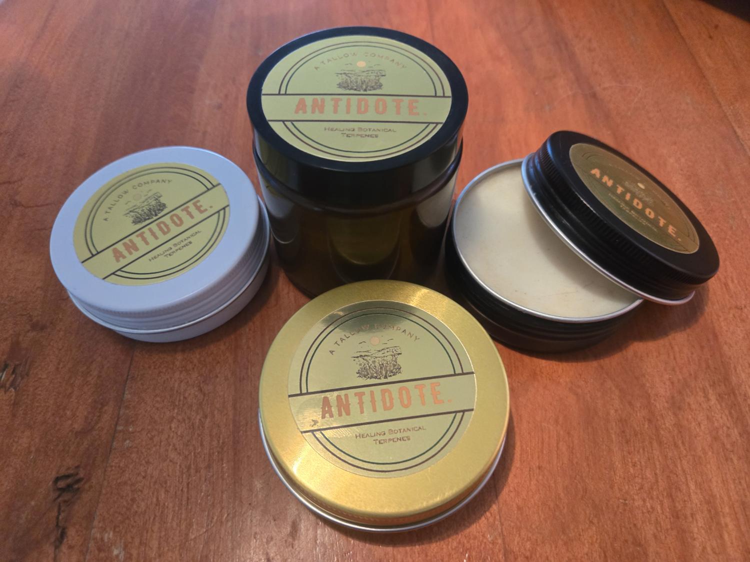 Antidote tins and amber glass on wood
